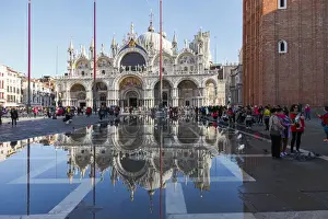 The St Marks Basilica reflected in high tide water (Acqua alta), Venice, Veneto