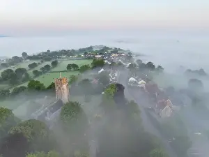 Morchard Bishop Prints: St Mary's Church and village emerging from morning mist at sunrise