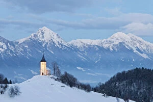 St. Primoz Church in winter, with Kamnik-Savinja Alps in background, Jamnik, Gorenjska