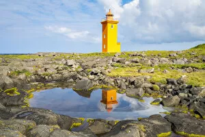 Stafnesviti Lighthouse with reflection in puddle, Sudurnesjabaer, Reykjanes Peninsula, Iceland