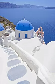 Staircase leading to blue domed church overlooking ocean, Oia, Santorini, Cyclades