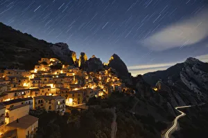 Star trail in the night sky over the old village of Castelmezzano, Dolomiti Lucane Star trail in the night sky over the old village of Castelmezzano, Dolomiti Lucane