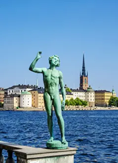 Stockholm County Prints: Statue in the City Hall Garden with Riddarholmen Islet in the background