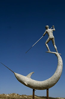 Marthas Vineyard Prints: A statue of Narwhal being speared at Menemsha Harbour