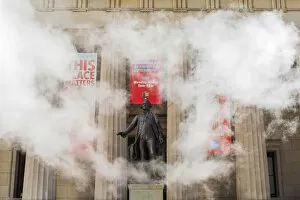 Statuer of George Washington surrounded by smoke in front of Federal hall, New York, USA