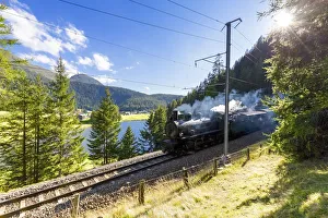 Steam train transits at Schwarzsee, Davos, Albula Valley, Graubünden, Switzerland