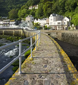 Stone harbour wall and village of Lynmouth on a summer morning, Exmoor National Park