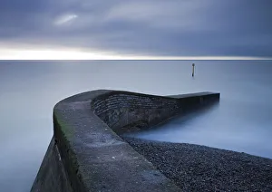Sidmouth Prints: Stone jetty on the seafront at Sidmouth, Devon, England. Winter