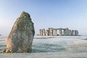 Stonehenge and the Heel Stone at dawn on a chill frosty winter morning, Wiltshire, England. Winter (January) 2022