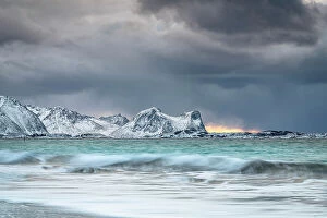 Climate Collection: Storm clouds at sunset over snowcapped mountains and cold arctic sea, Bovaer beach, Skaland
