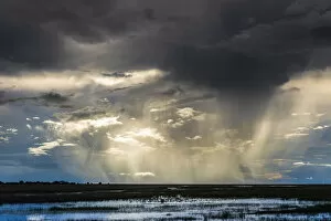 Zambia Gallery: Storm and rain clouds over grassland at sunset, Liuwa Plain National Park, Zambia