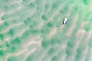 Overhead Prints: Stranded boat on the Town Bar near Rock, Cornwall, England. Summer (July) 2020