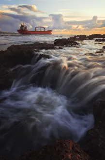 Stranded boat along the Tuscan coast at sunset, Livorno, Tuscany, Italy