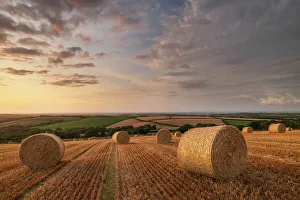 Straw Bales Prints: Straw Bales at sunset in rural Devon, Livaton, Devon, England. Summer (July) 2019