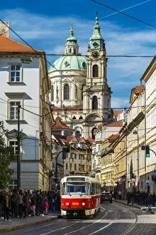 Images Dated 11th May 2017: Street in Mala Strana district with tram and St. Nicholas Church in the background