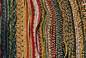 Lace Prints: Strings of colourful beads are laid out for sale