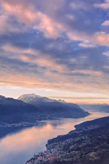 Stunning sunrise over Como Lake. San Bernardo Church, Monte Bregagno, Dongo, Como Lake