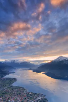 Stunning sunrise over the village of Dongo and Como Lake, from above. San Bernardo Church