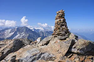 Summit cairn on Ofenhoren mountain with view at Bernese Alps, Urner Alps, canton Berne Summit cairn on Ofenhoren mountain with view at Bernese Alps, Urner Alps, canton Berne