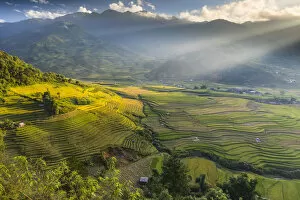 Sun beams over the mountains surrounding the rice terraces at Tu Le, Yen Bai Province