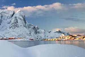 Reine Prints: Sun on fishing village surrounded by snowy peaks