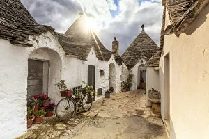 Images Dated 29th April 2020: Sun light filters between clouds and illuminates trullo house