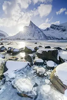 Mountain Peak Prints: Sun rays over Hatten mountain peak overlooking the frozen sea