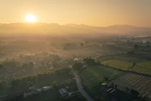 Sun rising over mountains and fields by Lake Inle, Nyaungshwe Township, Taunggyi District