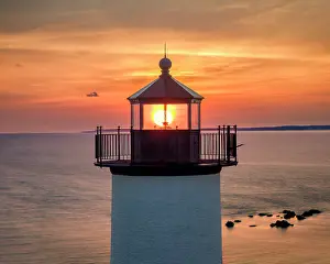 Cape Cod Prints: Sun rising through Tarpaulin Cove Lighthouse, Cape Cod, Naushon Island, Massachusetts, USA
