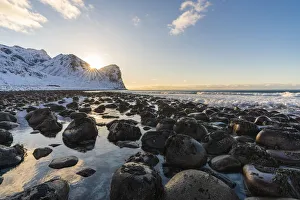 Nordland County Prints: The sun is setting behind Helligberget peak at Unstad Beach. Vestvagoy municipality