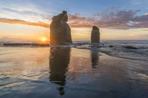 Tongaporutu Prints: The sun in setting down behind the Three Sisters. Tongaporutu, New Plymouth district