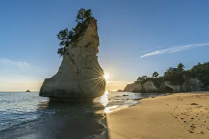 Sun behind Te Hoho rock at Cathedral Cove