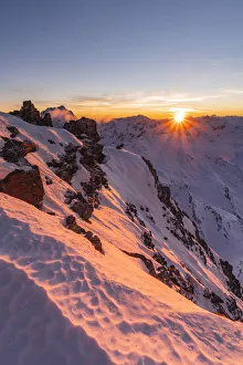Last sunlight from Vallombrina mountain in the Stelvio National Park during a winter Last sunlight from Vallombrina mountain in the Stelvio National Park during a winter