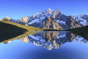 The sunlit Mont Blanc is reflected in Lac Checrouit. Checrouit Lake, Veny Valley