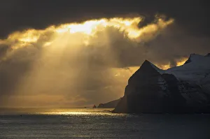Sunrays above the islands of Mykines. Faroe Islands