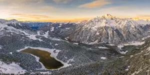 Sunrise aerial view of Lake Palu after an early snowfall Malenco Valley Valtellina