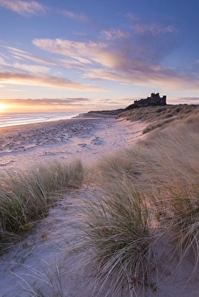 Sunrise over Bamburgh Beach and Castle from the sand dunes, Northumberland, England