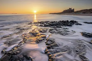 Northumberland Prints: Sunrise over Bamburgh Castle and beach, Northumberland, England. Winter (March) 2025