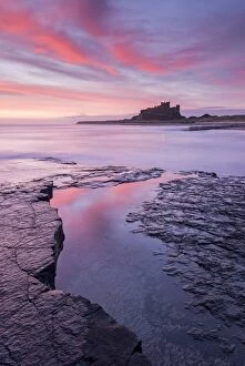 Coast Gallery: Sunrise over Bamburgh Castle on the Northumberland coast, England. Spring (March) 2015