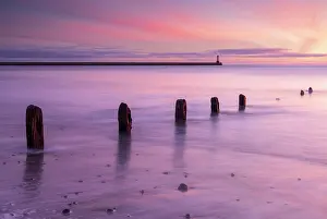 Northumberland Prints: Sunrise over Berwick Lighthouse and pier from Spittal Beach at Berwick upon Tweed