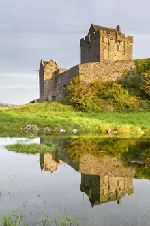 Connacht Prints: Sunrise at the Dunguaire Castle reflected in its moat. County Galway, Connacht province