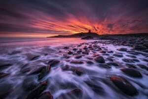 Images Dated 2nd August 2022: sunrise over Dunstanburgh Castle and Embelton Beach, Northumberland, England, UK