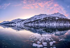 Circle Prints: Sunrise on ice bubbles trapped in Lake Sils with Piz Da La Margna in background
