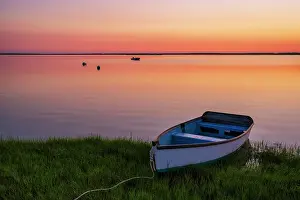 Estuary Prints: Sunrise from a marsh on Cape Cod with a single rowboat, Orleans, Massachusetts, USA