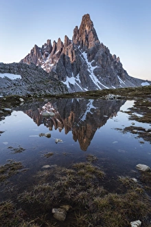 Lavaredo Prints: Sunrise of Mount Paterno reflected in a puddle, Natural Park Three Peaks, Sesto Pusteria