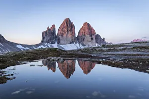 Lavaredo Prints: Sunrise of the Three Peaks reflected in a puddle, Natural Park Three Peaks, Sesto Pusteria