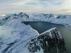 Images Dated 20th September 2023: Sunrise over the snowcapped Segla mountain overlooking a fjord, aerial view, Senja, Troms county
