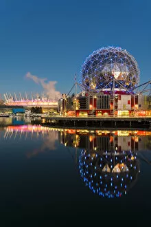 Sunrise view of False Creek inlet with Telus World of Science and BC Place Stadium behind