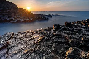 Basalt Prints: Sunrise over the volcanic rock formations of Ghenh Da Dia bassalt rocks, Phu Yen, Vietnam