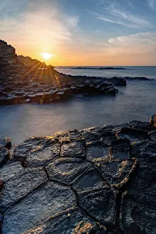 Basalt Prints: Sunrise over the volcanic rock formations of Ghenh Da Dia bassalt rocks, Phu Yen, Vietnam